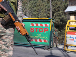 Security forces checking vehicles before letting them move ahead of Tangmarg