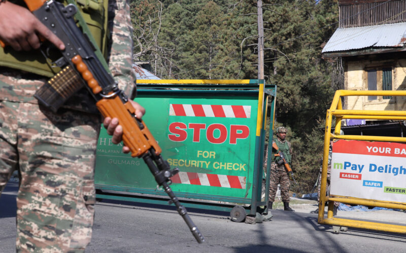 Security forces checking vehicles before letting them move ahead of Tangmarg